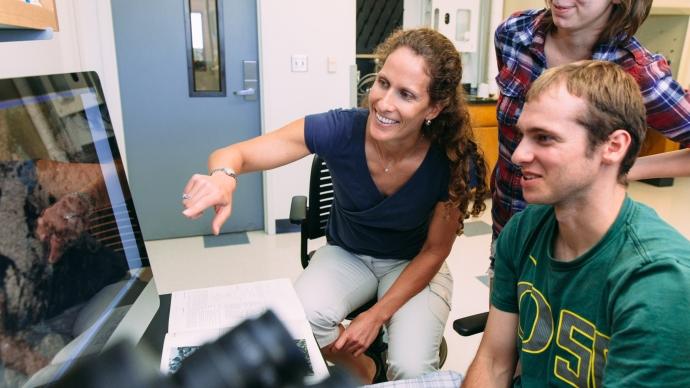 kathy surpless in lab with two students