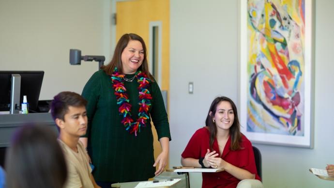 Heather Haynes Smith stands with two students in a classroom