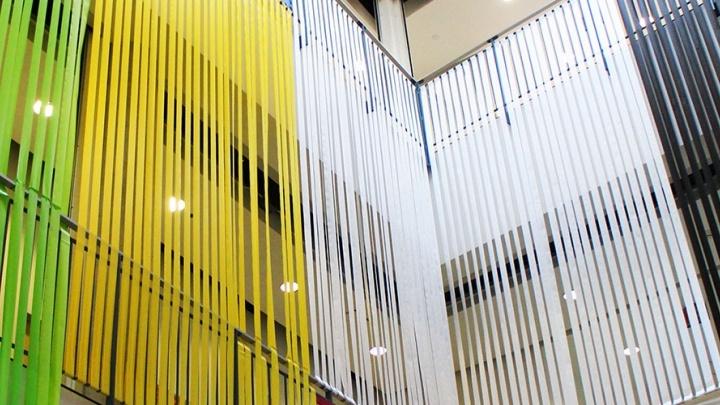 Colored ribbons spanning two stories are part of art exhibition