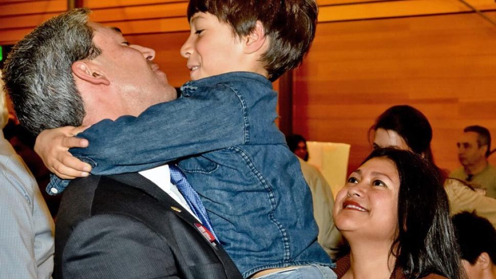 Ron Nirenberg lifts his eight-year old son, Jonah, in an embrace