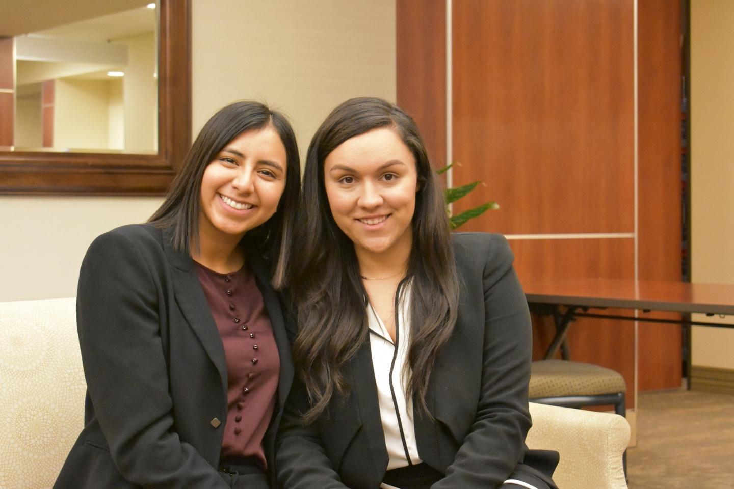 Students Gabbie and Sabrina sit together at a local hospital. 