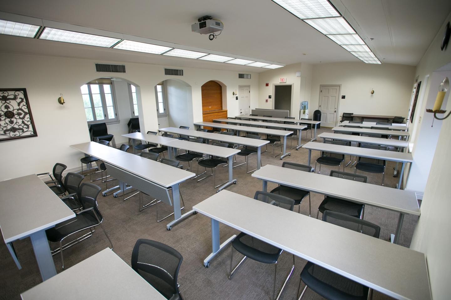 Seven rows of desks in the 3rd floor classroom at Holt Center