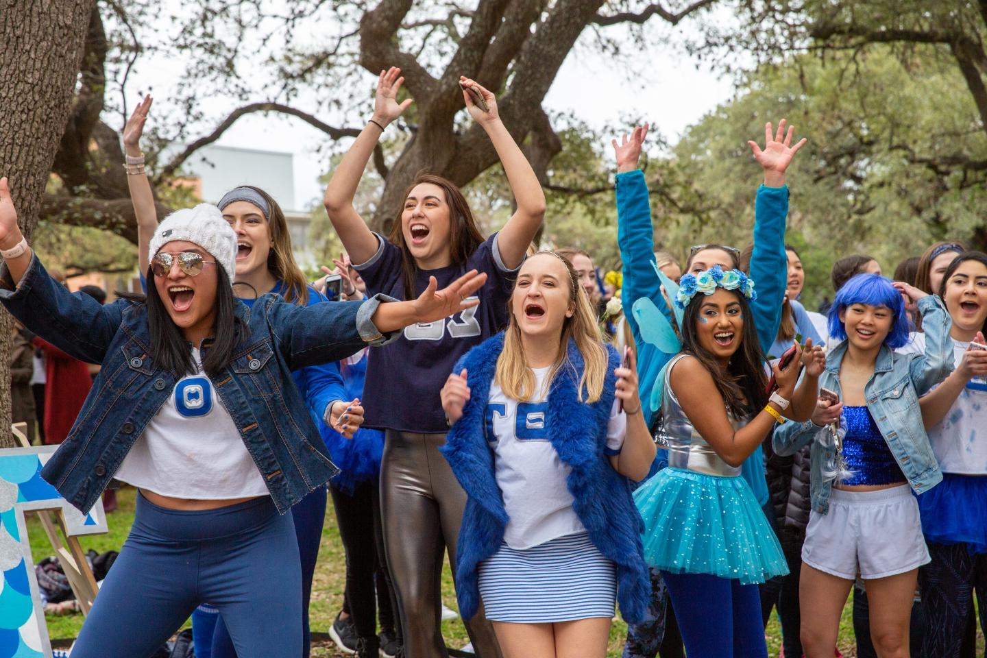 Women in the Sigma Theta Tau sorority cheer for their new members at Bid Day.