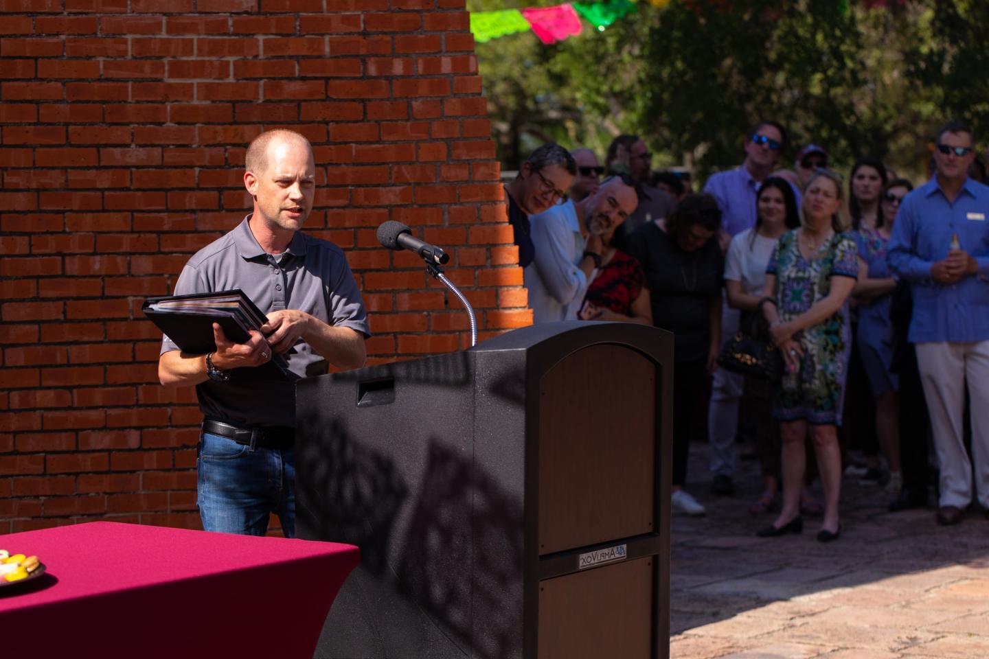 Trey Dunn speaking at ceremony