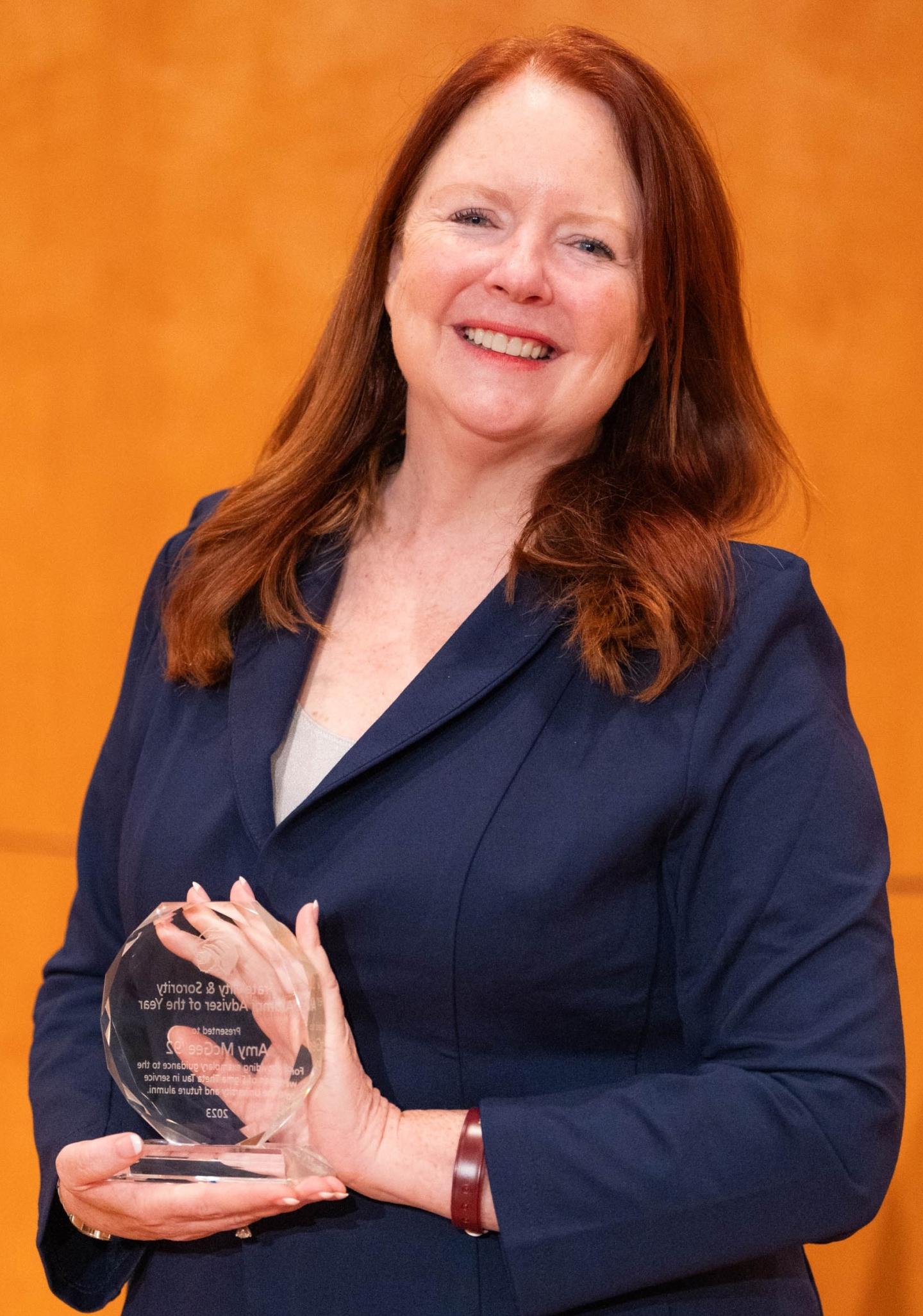 photo of Amy McGee '92 holding an Alumni Award