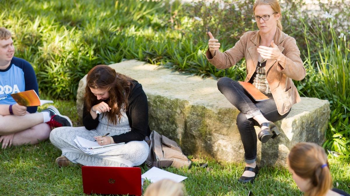 Professor giving a lecture outdoors