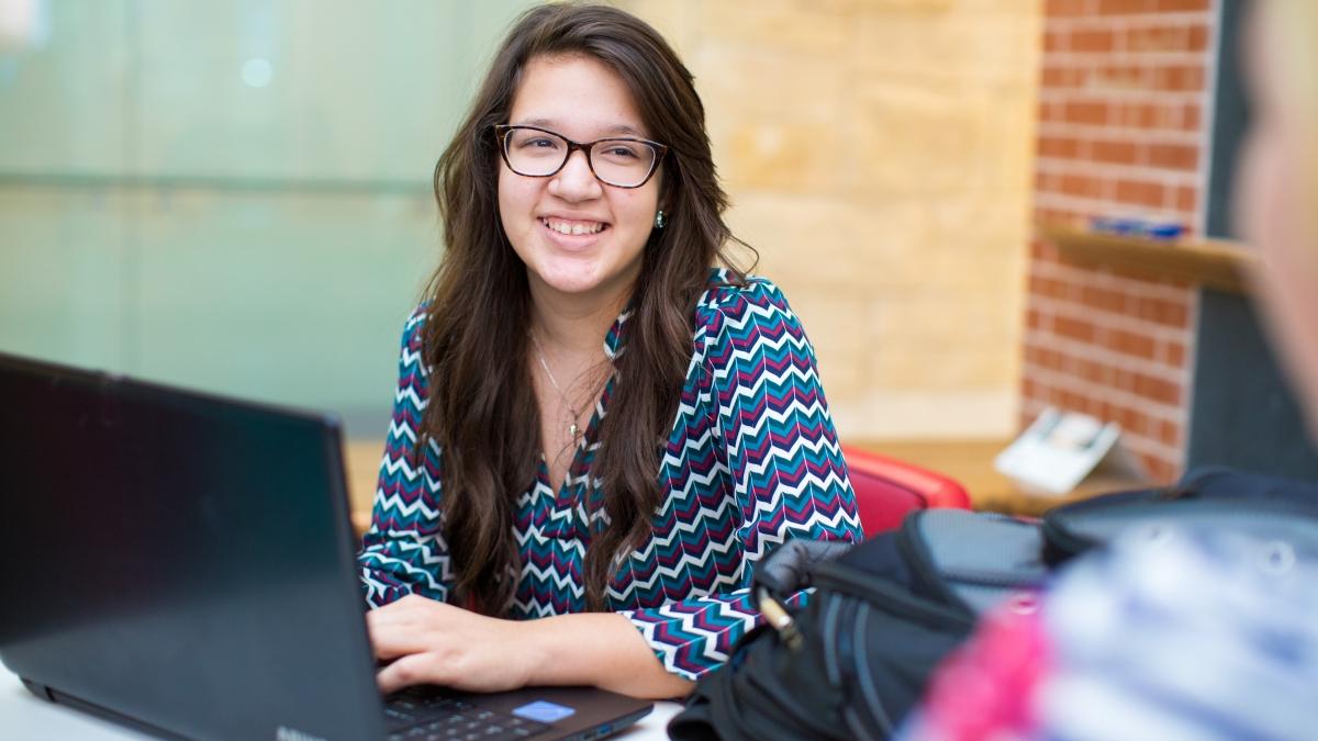 Janett Munoz sitting with a laptop 